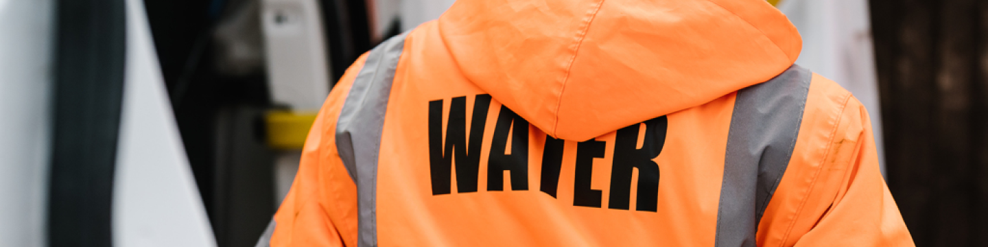 Northumbrian Water employee wearing orange jacket
