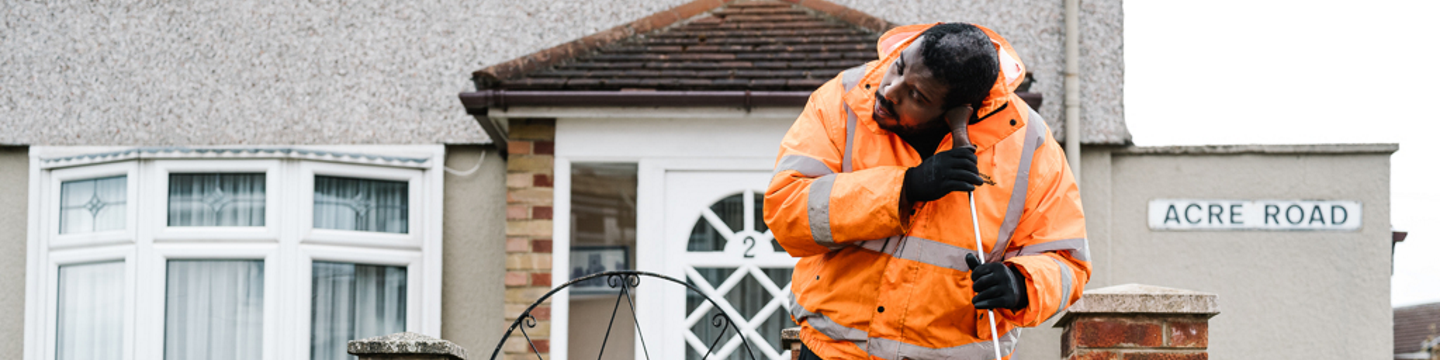 Northumbrian Water employee wearing orange hi-vis jacket working
