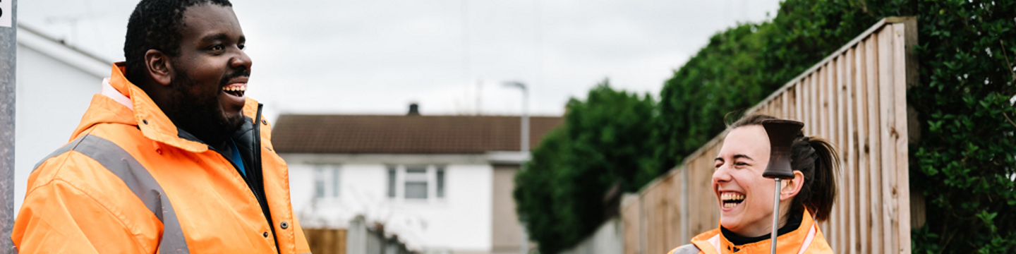 Two Northumbrian Water workers smiling 