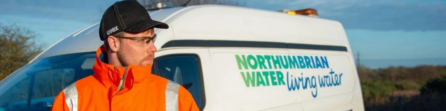 Northumbrian Water employee standing outside of van